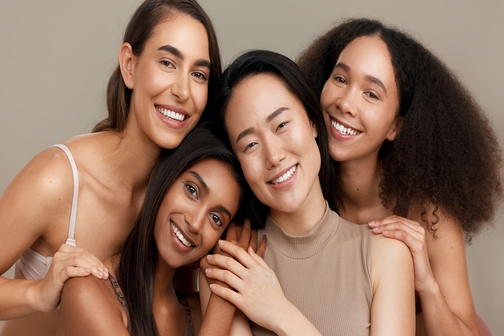 Group of four women, each with unique skin tone and texture, all showing beautiful and youthful skin after AquaGold treatments