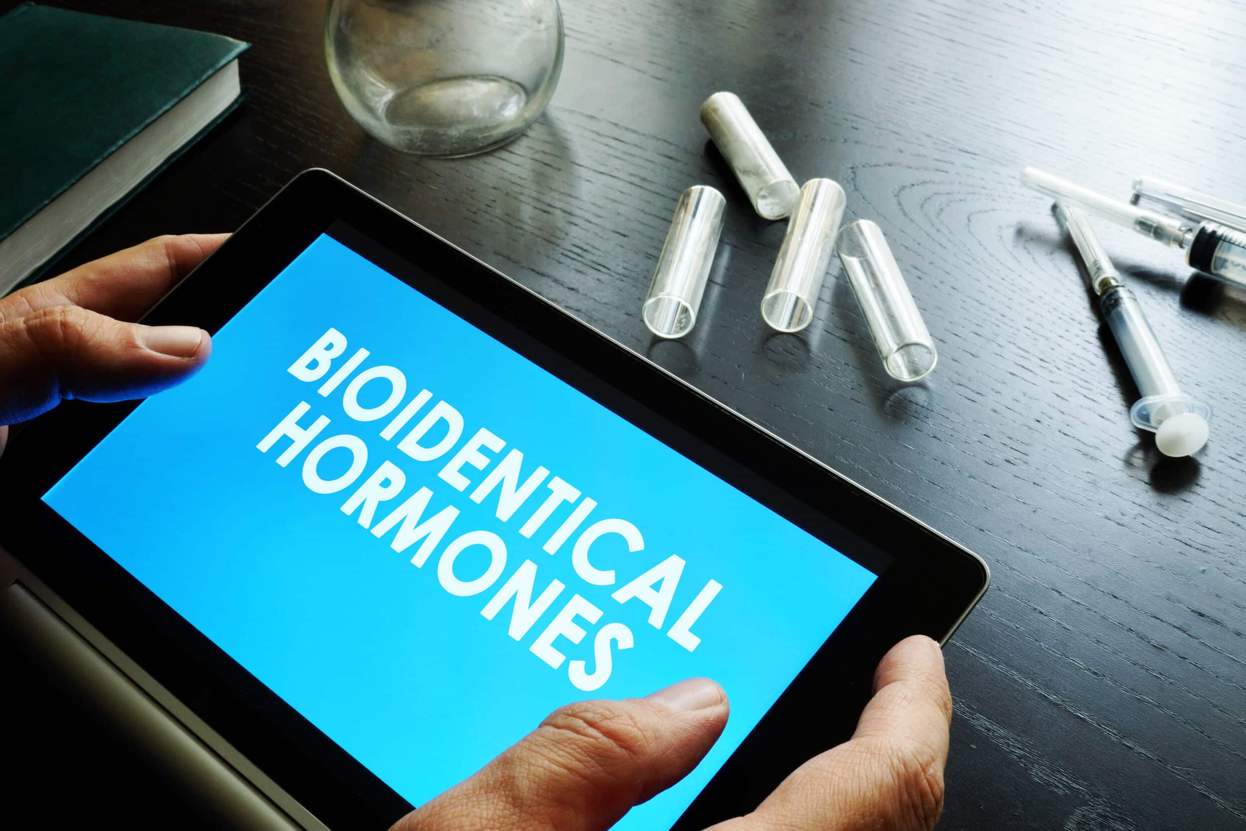 A digital tablet displaying the words "Bioidentical Hormones"