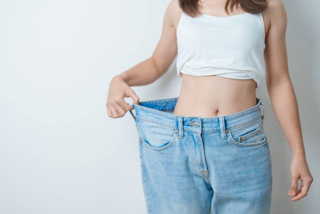 Woman showing results after weight loss.